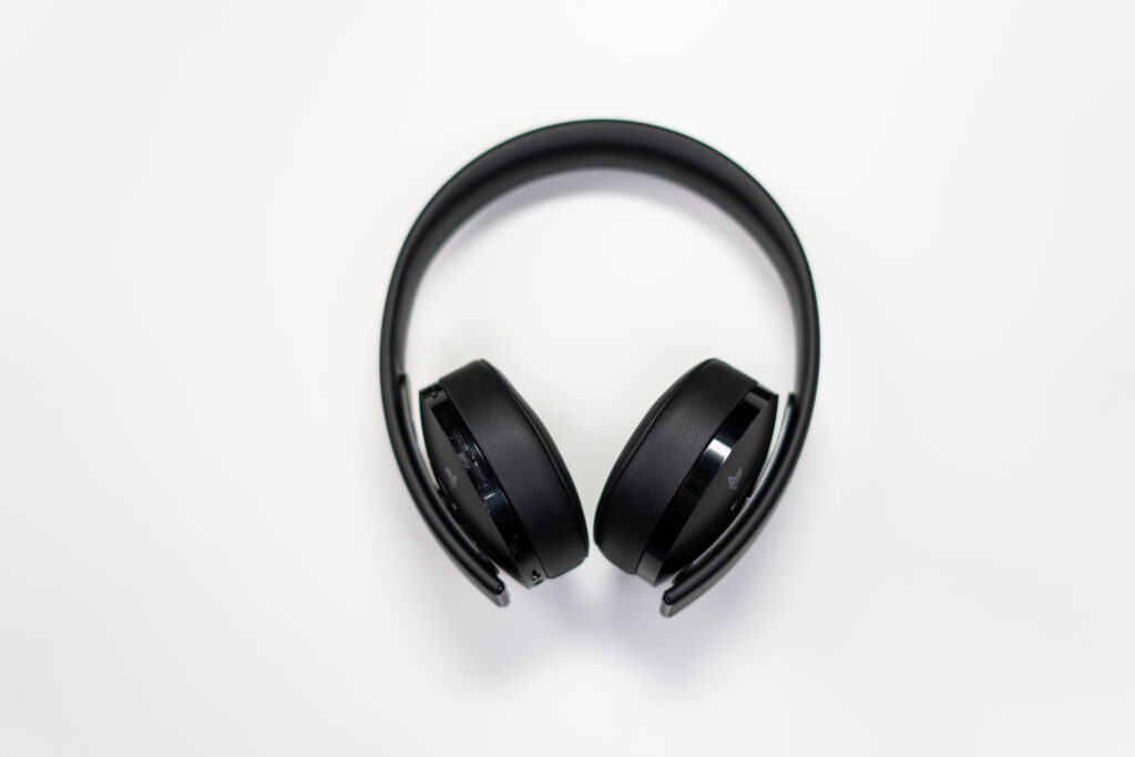 Black wireless headphones on white surface